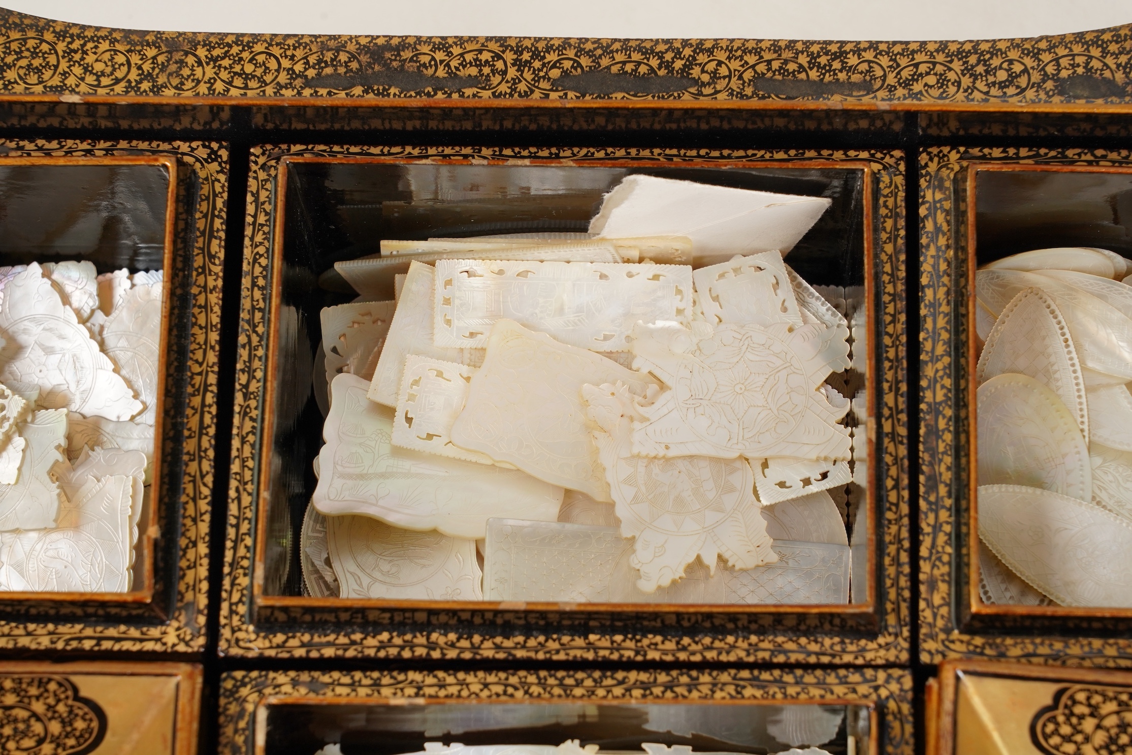 Two Chinese gilt decorated black lacquer games boxes, containing numerous mother-of-pearl counters, 19th century